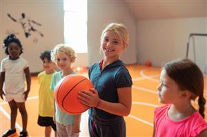 Young Kids In The Gym Holding A Basketball Young Kids In The Gym Holding A Basketball